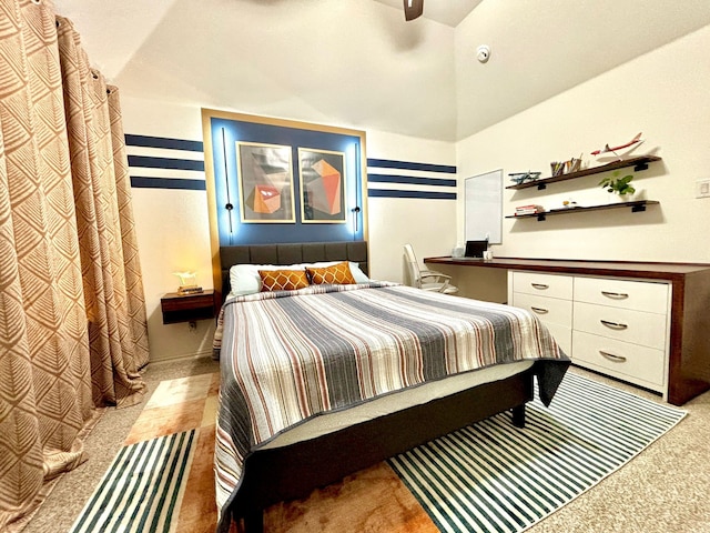 carpeted bedroom with built in desk, ceiling fan, and a high ceiling