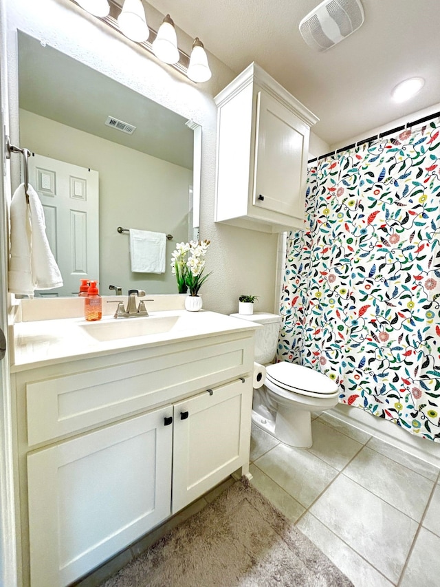 bathroom with vanity, a shower with shower curtain, tile patterned floors, and toilet