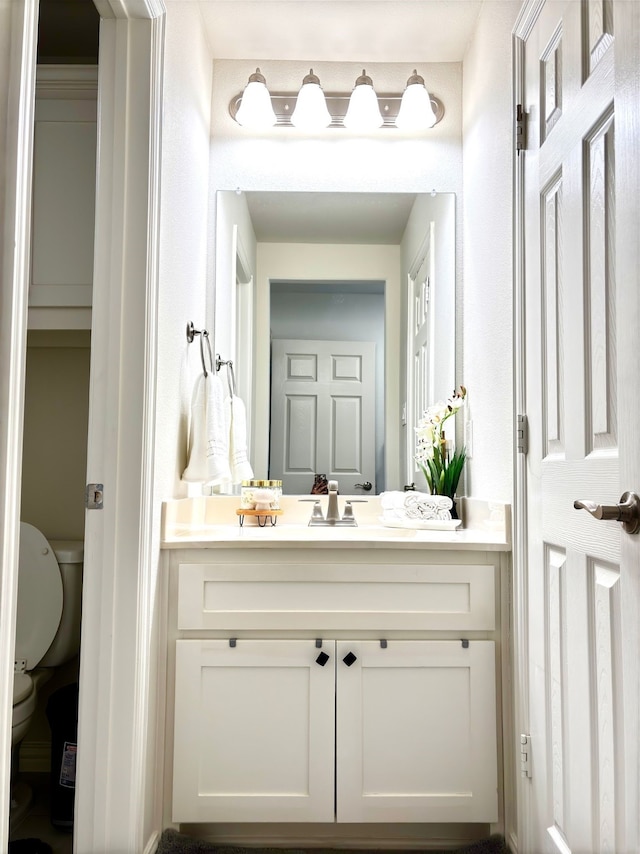 bathroom featuring vanity and toilet