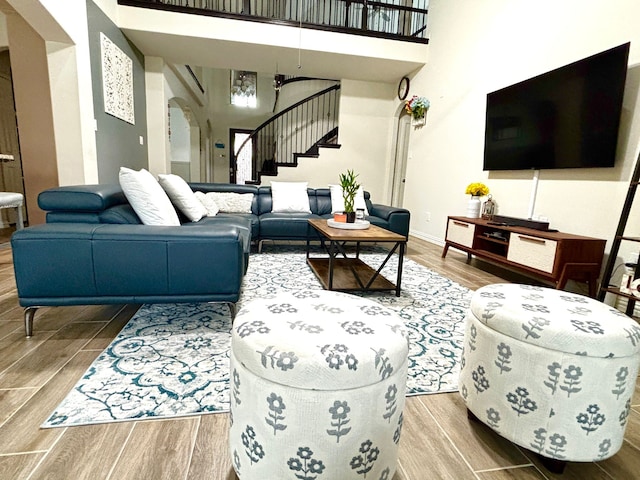 living room featuring a towering ceiling