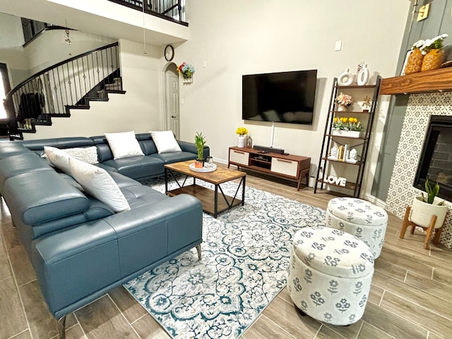 living room with a towering ceiling and a fireplace