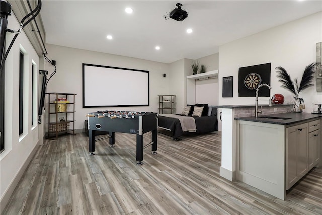 playroom featuring light wood-type flooring and sink