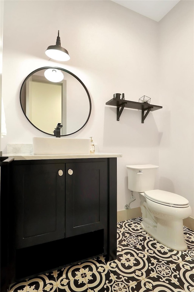 bathroom featuring vanity, toilet, and tile patterned flooring