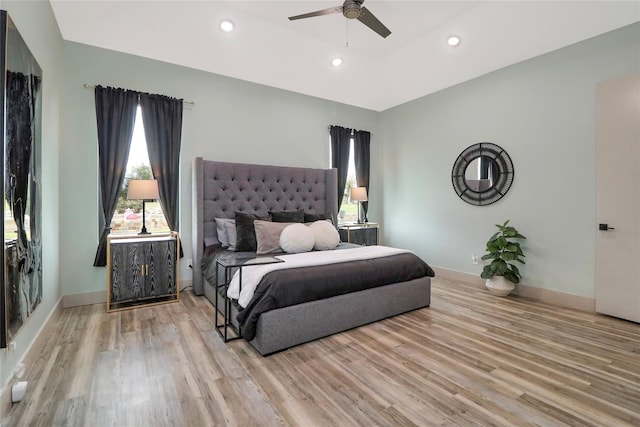 bedroom with light hardwood / wood-style flooring and ceiling fan