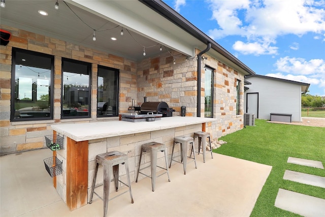 view of patio / terrace featuring a bar and a grill