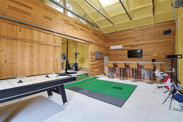 game room with an AC wall unit, wooden walls, and lofted ceiling