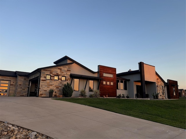 contemporary home featuring a front yard and a garage