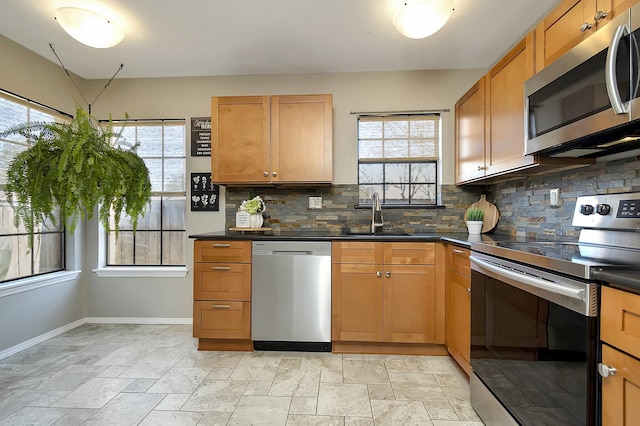 kitchen with sink, backsplash, and stainless steel appliances