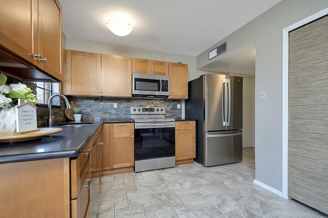 kitchen with sink, stainless steel appliances, and tasteful backsplash