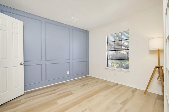 unfurnished bedroom featuring a closet and light wood-type flooring