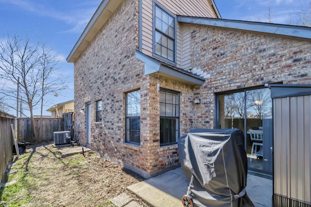 view of side of home featuring central air condition unit and a patio area