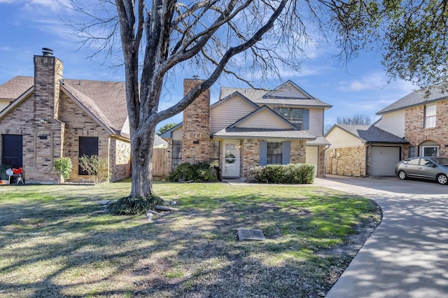 view of front of property featuring a garage and a front lawn