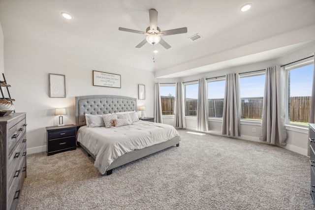 bedroom with ceiling fan, light colored carpet, and lofted ceiling