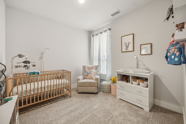 carpeted bedroom featuring a crib