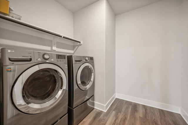 washroom featuring independent washer and dryer and dark hardwood / wood-style floors