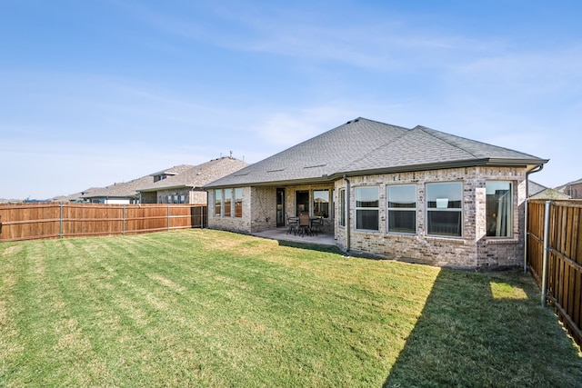 rear view of property with a patio area and a lawn