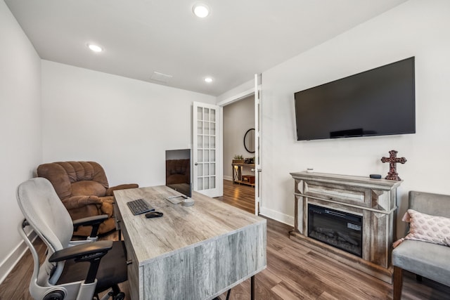 office with wood-type flooring and french doors