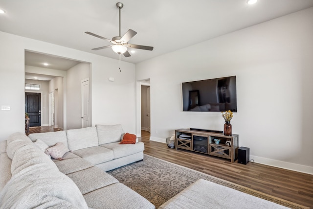 living room with hardwood / wood-style flooring and ceiling fan