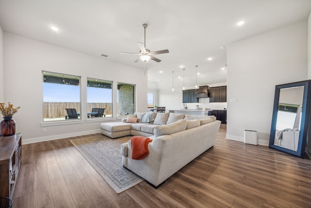 living room with ceiling fan and dark hardwood / wood-style flooring