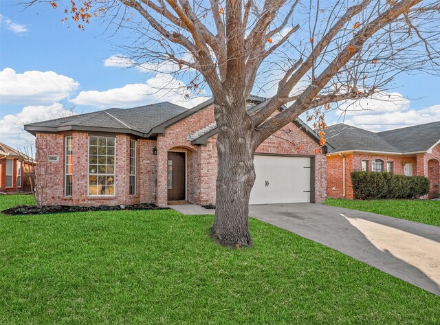 single story home featuring a garage and a yard