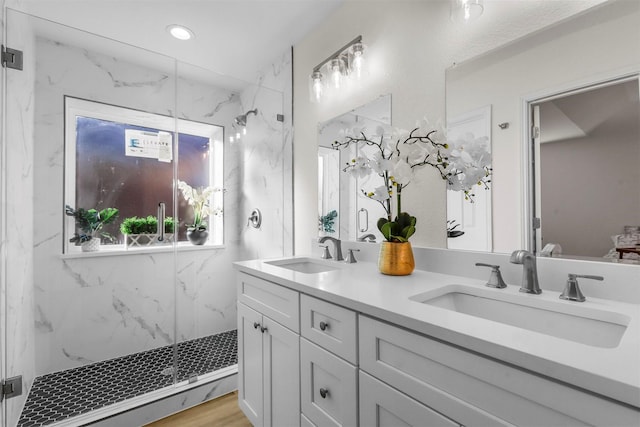 bathroom with vanity, a baseboard heating unit, wood-type flooring, and walk in shower