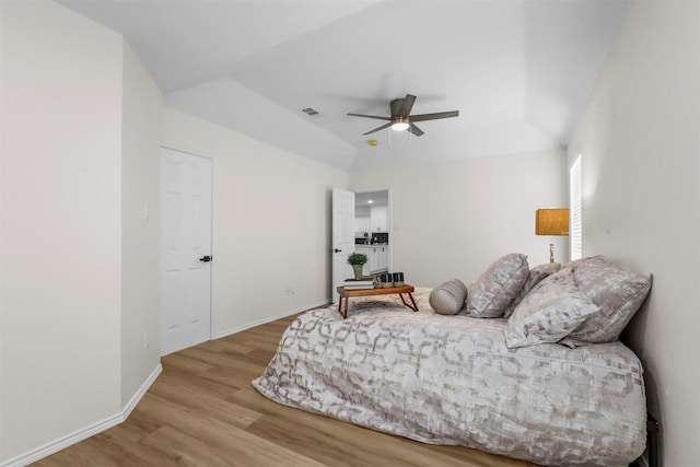 bedroom featuring vaulted ceiling, light hardwood / wood-style floors, and ceiling fan