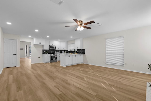 unfurnished living room featuring ceiling fan and light hardwood / wood-style flooring