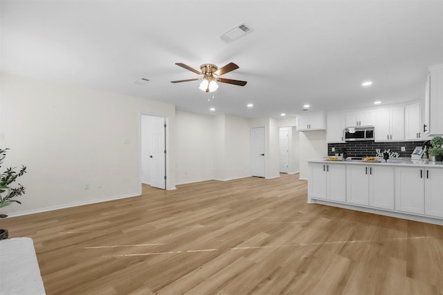 living room with ceiling fan and light wood-type flooring