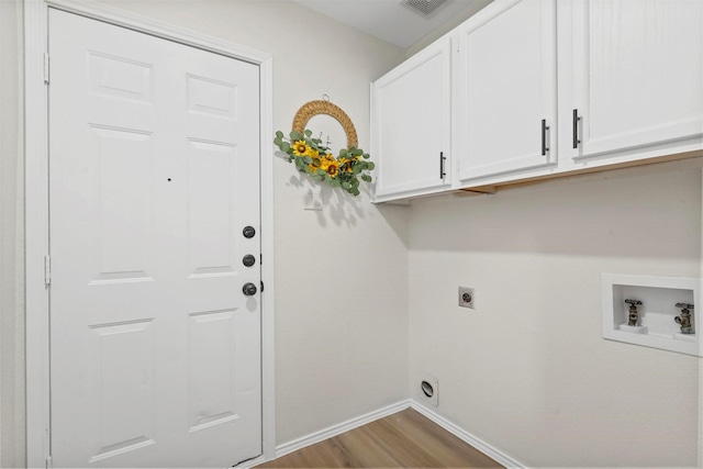 washroom with washer hookup, cabinets, light hardwood / wood-style flooring, and hookup for an electric dryer