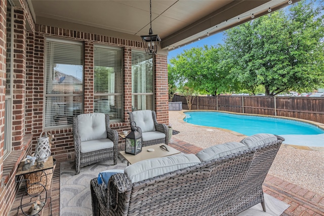 view of swimming pool featuring an outdoor living space and a patio