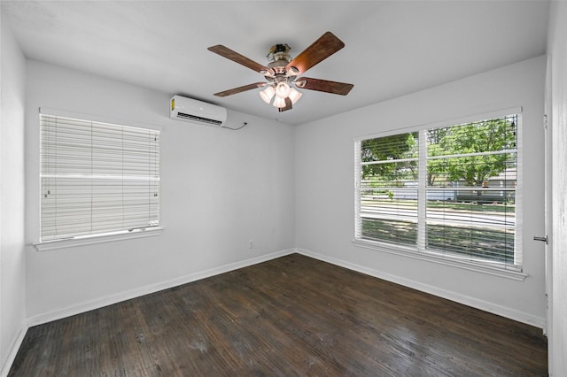 unfurnished room featuring a healthy amount of sunlight, a wall mounted AC, dark hardwood / wood-style floors, and ceiling fan