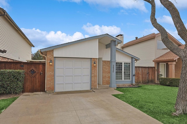 view of front of house with brick siding, a front lawn, fence, an attached garage, and a gate