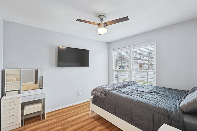 bedroom with ceiling fan and light hardwood / wood-style flooring