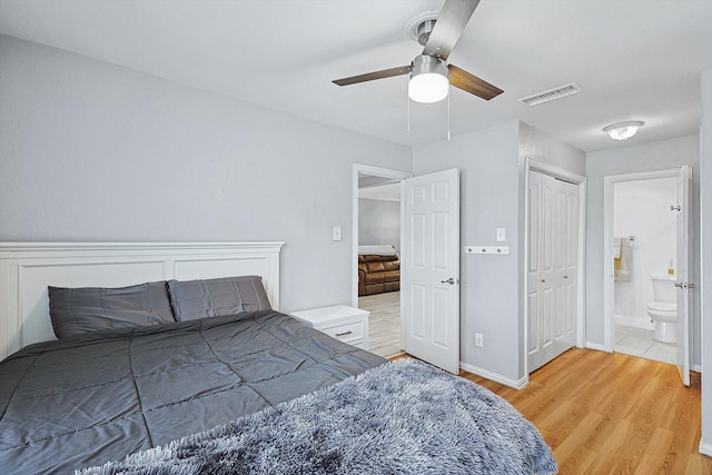 bedroom featuring a closet, ceiling fan, ensuite bathroom, and hardwood / wood-style flooring