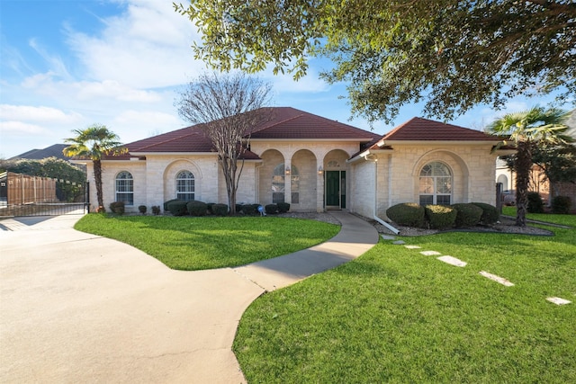 mediterranean / spanish-style home featuring a front lawn