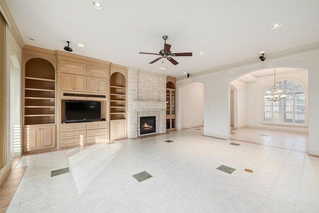 unfurnished living room with a fireplace, built in features, ceiling fan, light tile patterned floors, and crown molding