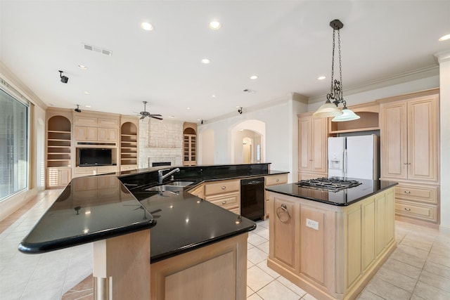 kitchen featuring a spacious island, decorative light fixtures, built in features, sink, and white fridge with ice dispenser