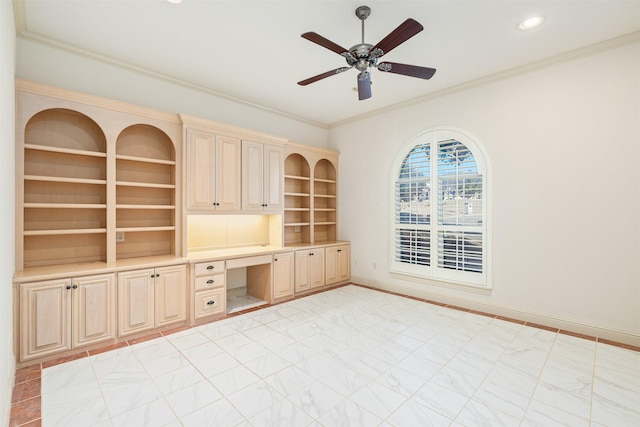 unfurnished office with ceiling fan, built in shelves, crown molding, and built in desk