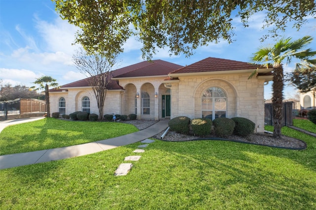 mediterranean / spanish-style house with a front lawn