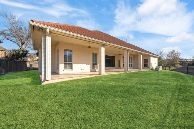 rear view of house with a patio area and a yard