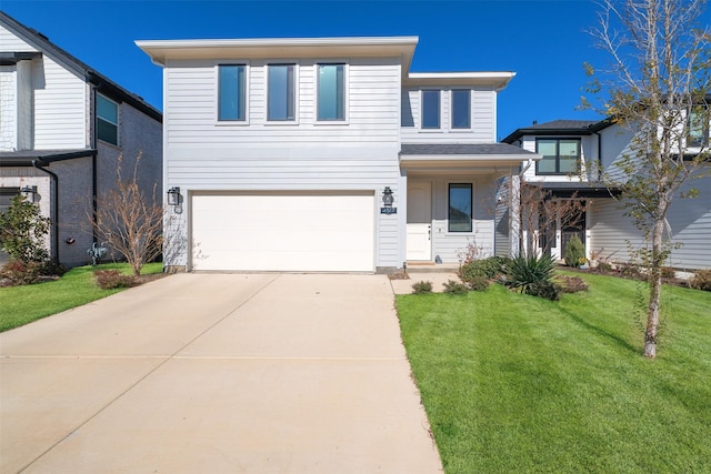 view of front of home with a garage and a front lawn