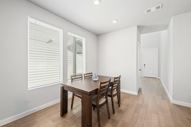 dining space with light hardwood / wood-style flooring