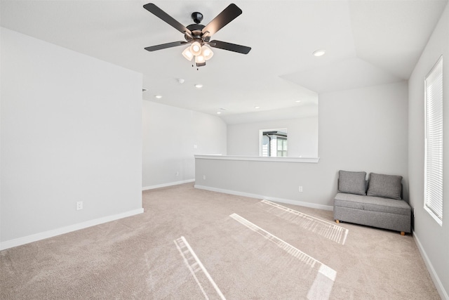 unfurnished room with ceiling fan, light colored carpet, and lofted ceiling