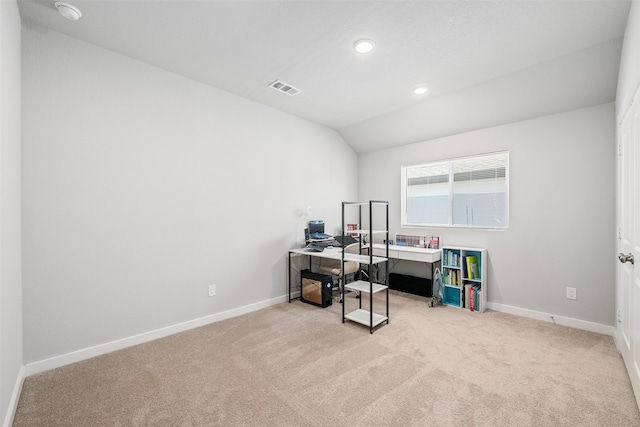 home office featuring light carpet and vaulted ceiling