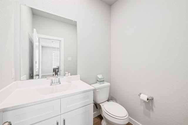 bathroom featuring hardwood / wood-style floors, toilet, and vanity