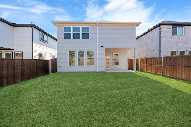 rear view of property with a patio area and a yard