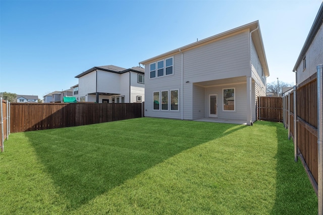 back of house featuring a patio area and a yard