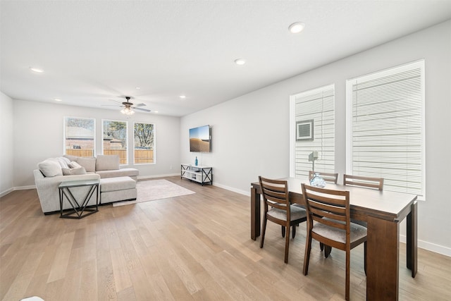 dining area with light wood-type flooring and ceiling fan