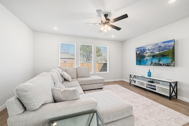 living room featuring ceiling fan and hardwood / wood-style floors