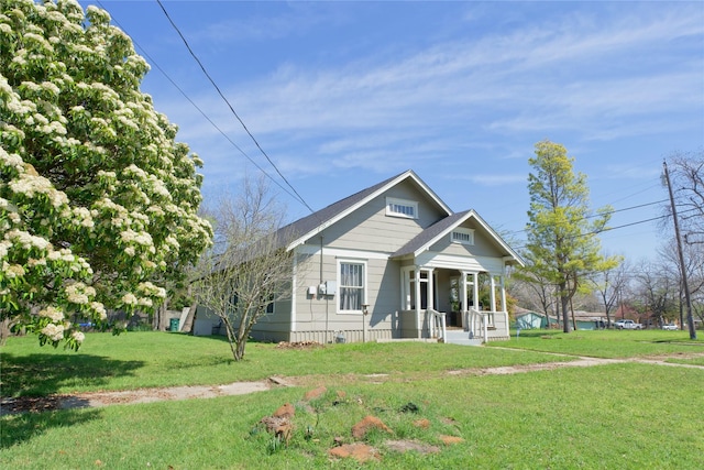 view of front of home with covered porch and a front yard